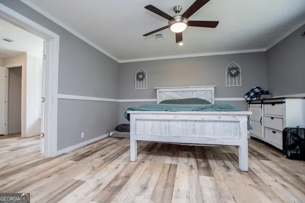 a bedroom with a bed and a chandelier