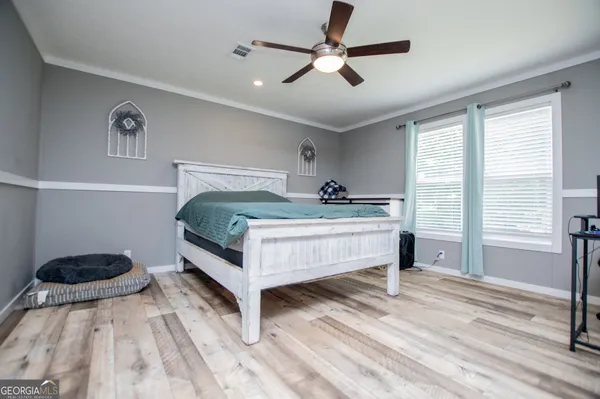 a bedroom with bed and a window