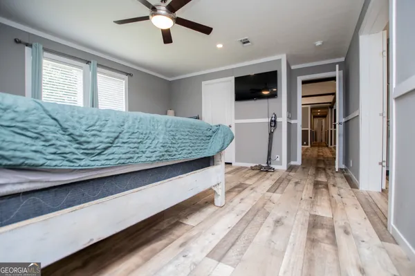 a view of livingroom with kitchen view and wooden floor