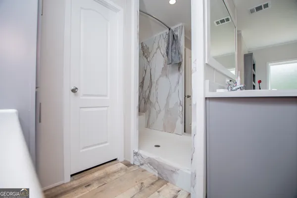 a bathroom with a bathtub and a shower
