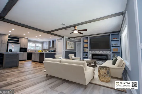 a kitchen with kitchen island granite countertop a sink a counter top space stainless steel appliances and cabinets