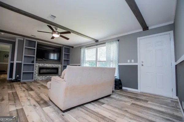 a living room with furniture and a flat screen tv