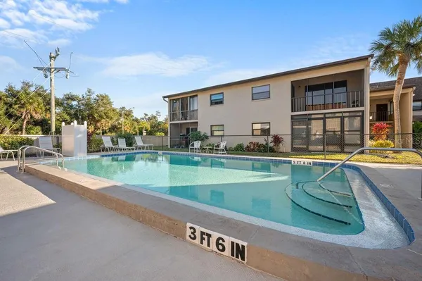 a view of a house with swimming pool and sitting area