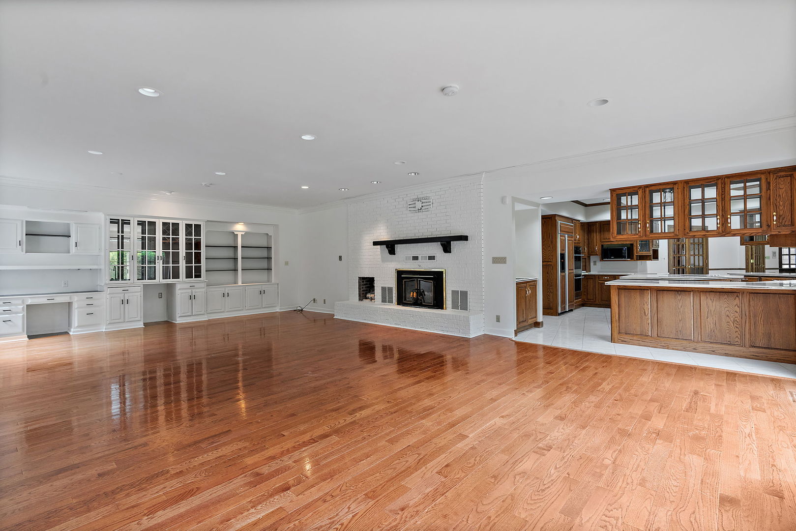 345 Bethany Road DeKalb, IL 60115 - Photo 17 of 71 a view of empty room with wooden floor and fireplace