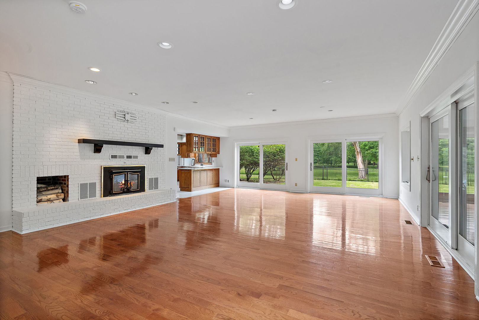 345 Bethany Road DeKalb, IL 60115 - Photo 18 of 71 a view of an empty room with wooden floor and a fireplace