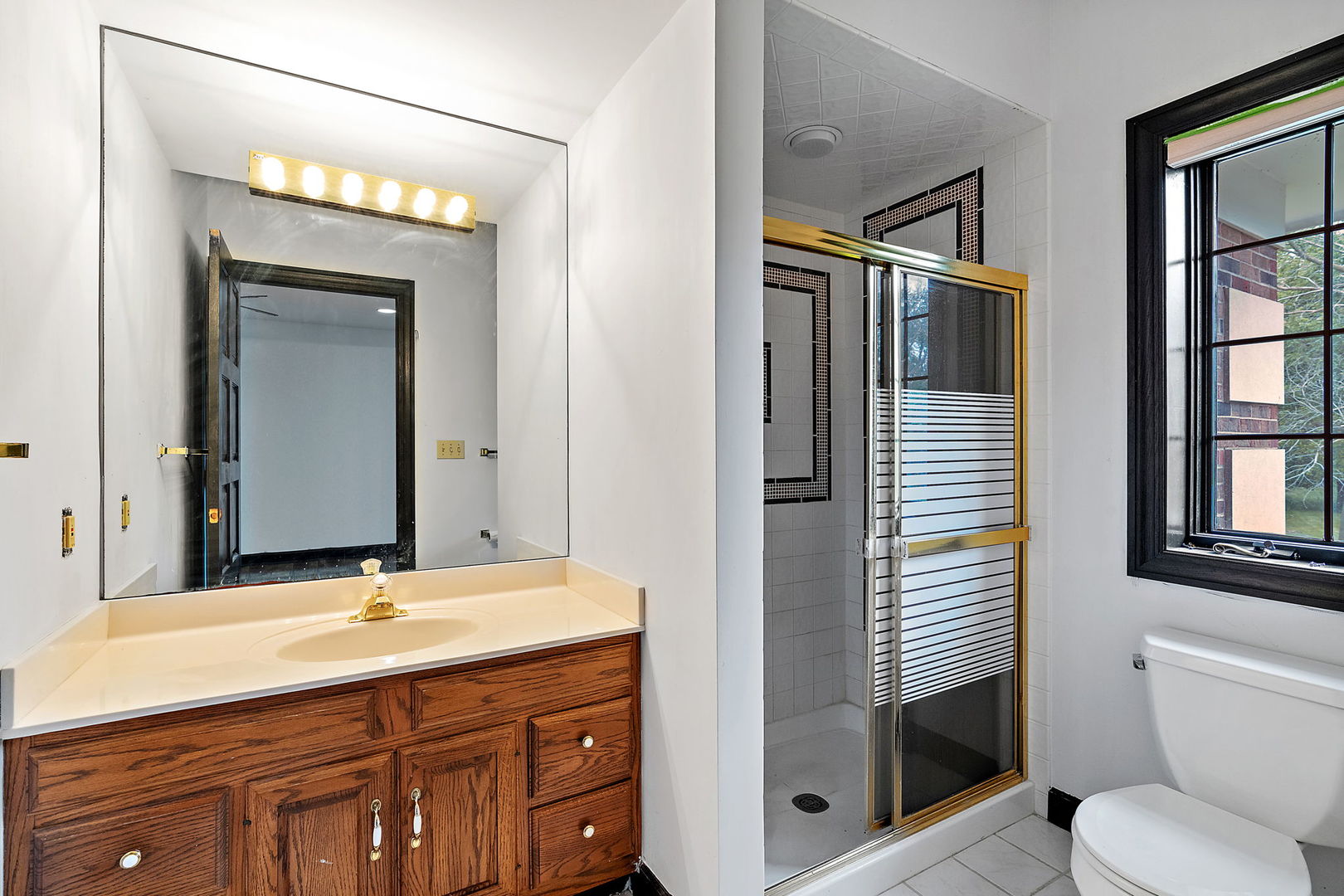 345 Bethany Road DeKalb, IL 60115 - Photo 26 of 71 a bathroom with a toilet sink shower and mirror