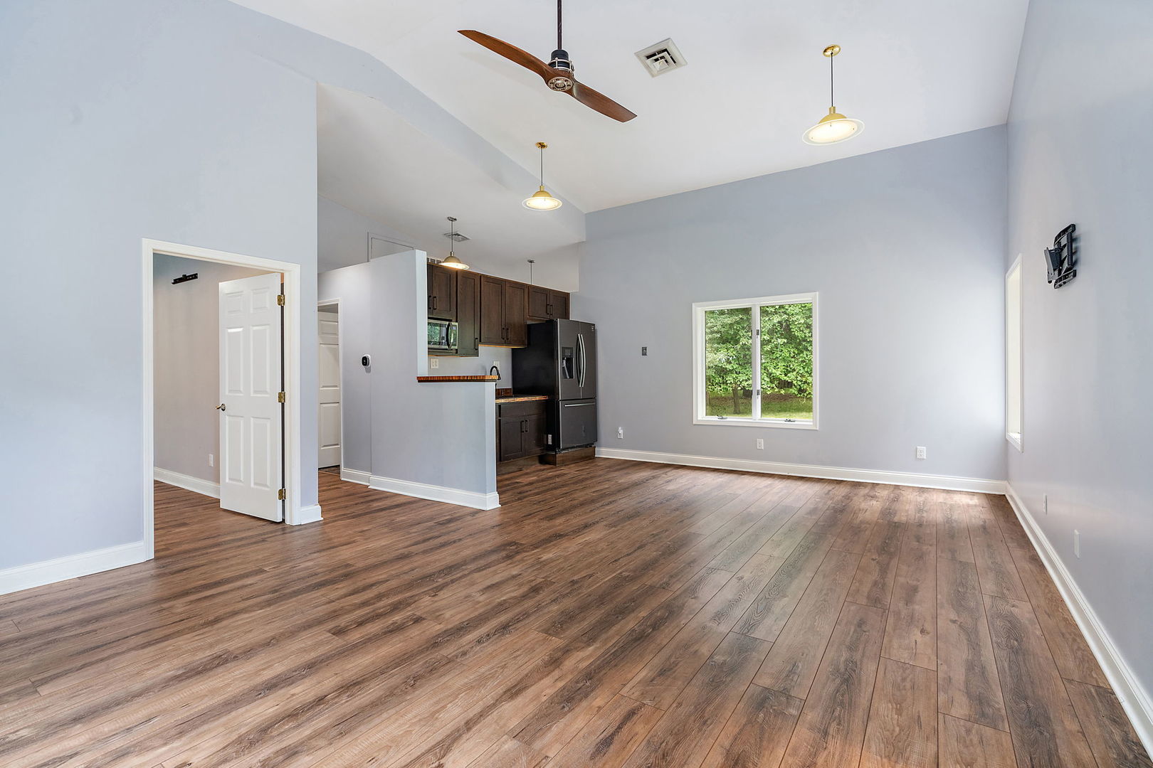 345 Bethany Road DeKalb, IL 60115 - Photo 42 of 71 an empty room with wooden floor kitchen view and a window