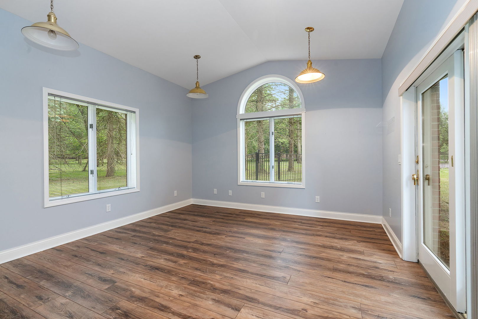 345 Bethany Road DeKalb, IL 60115 - Photo 45 of 71 an empty room with wooden floor chandelier and windows