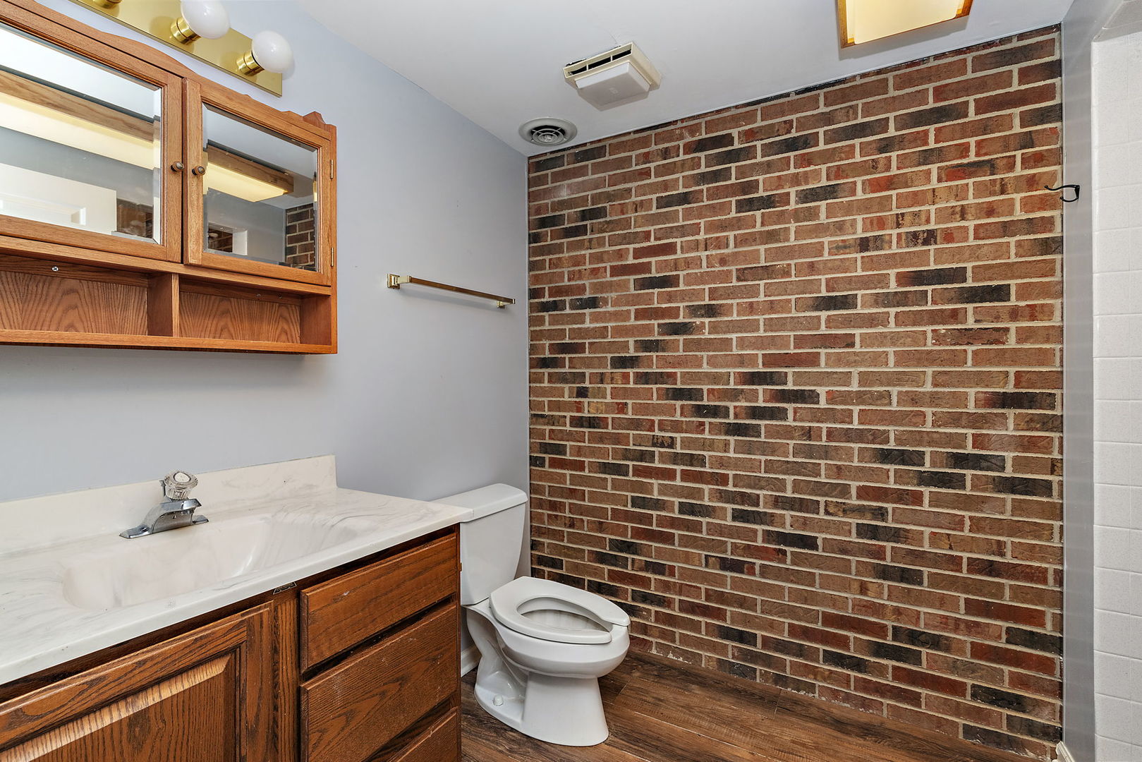 345 Bethany Road DeKalb, IL 60115 - Photo 47 of 71 a bathroom with a sink a toilet and a mirror