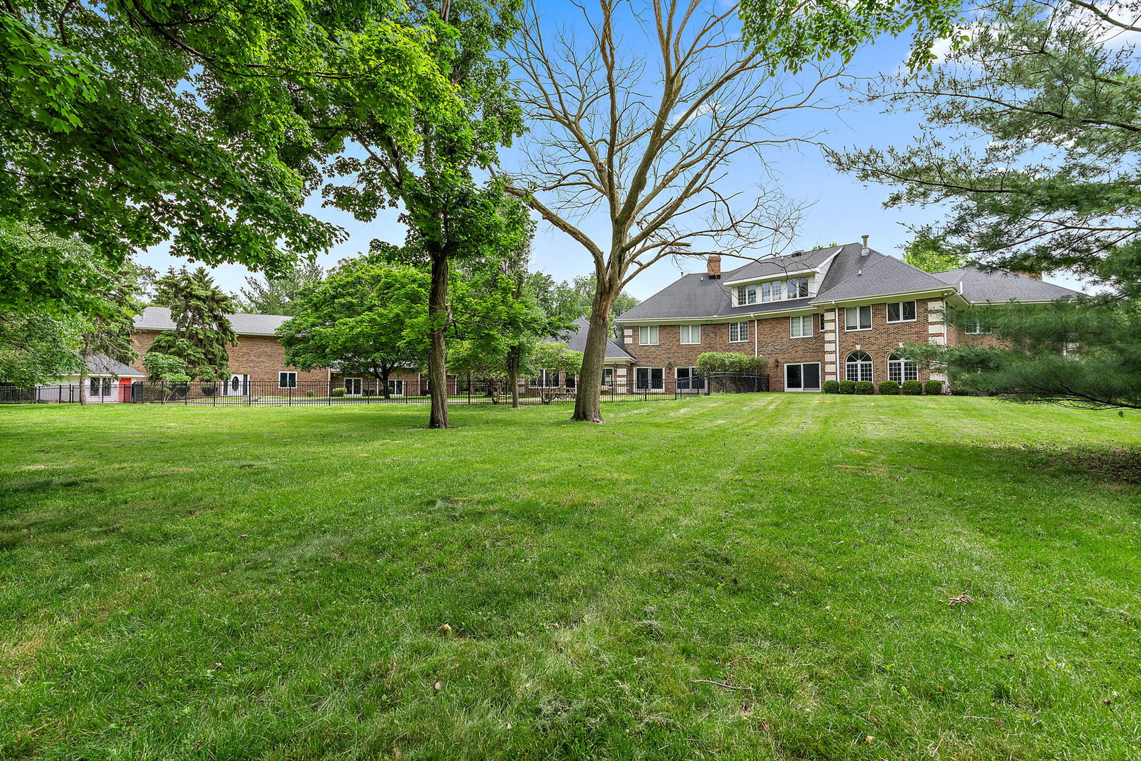 345 Bethany Road DeKalb, IL 60115 - Photo 57 of 71 a view of white house with a big yard and large trees