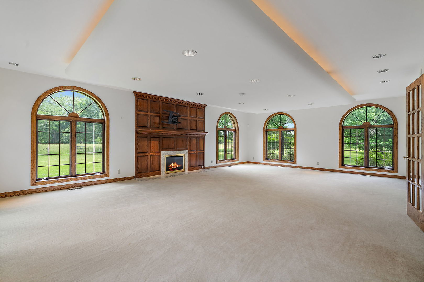 345 Bethany Road DeKalb, IL 60115 - Photo 8 of 71 a view of an empty room with a fireplace and a large window