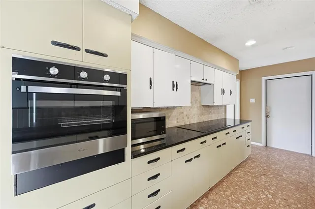 a large kitchen with stainless steel appliances