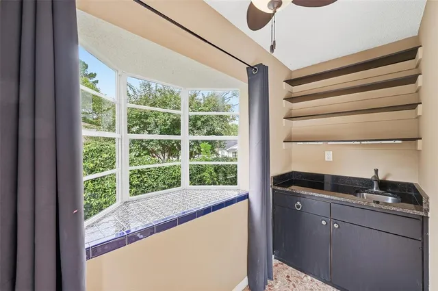 an empty room with large windows and outer view