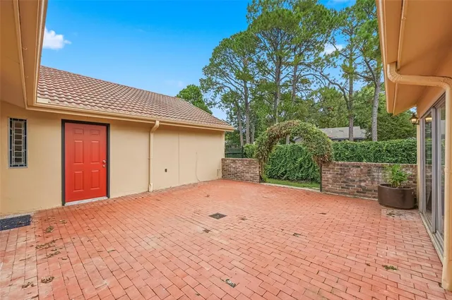 a view of barn with a small yard and large trees