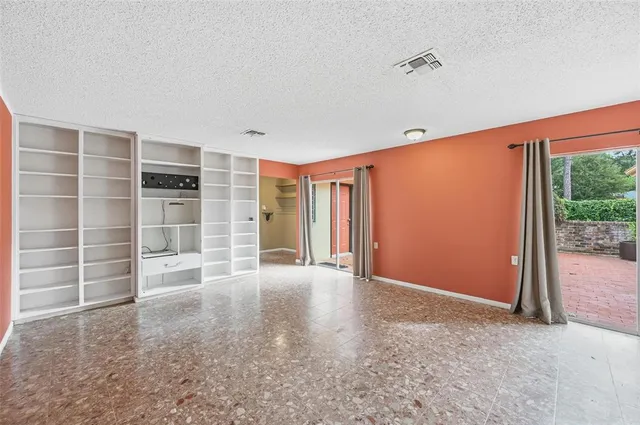 a view of an empty room with a balcony and balcony