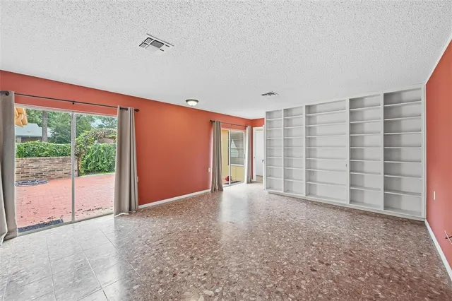 a kitchen with granite countertop white cabinets and stainless steel appliances