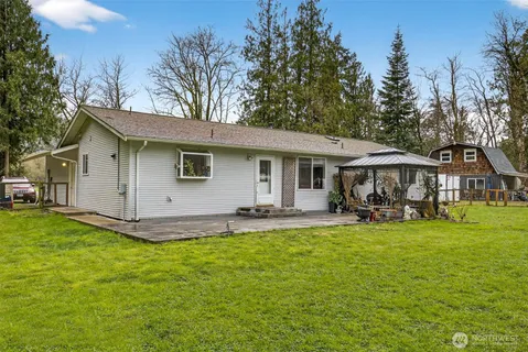 a view of a house with a yard and sitting area