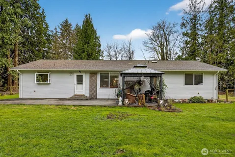 a front view of house with yard and outdoor seating