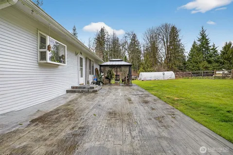 a view of a house with yard and sitting area