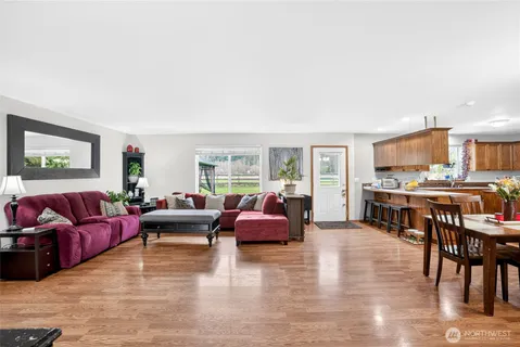 a living room with furniture and kitchen view