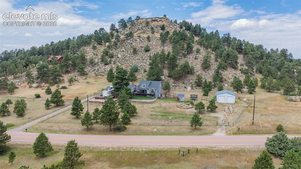17370 Sweet Road Peyton, CO 80831 - Photo 6 of 38 Good aerial overview of the entire property showing the paved driveway, fenced areas, outbuildings and updated home.