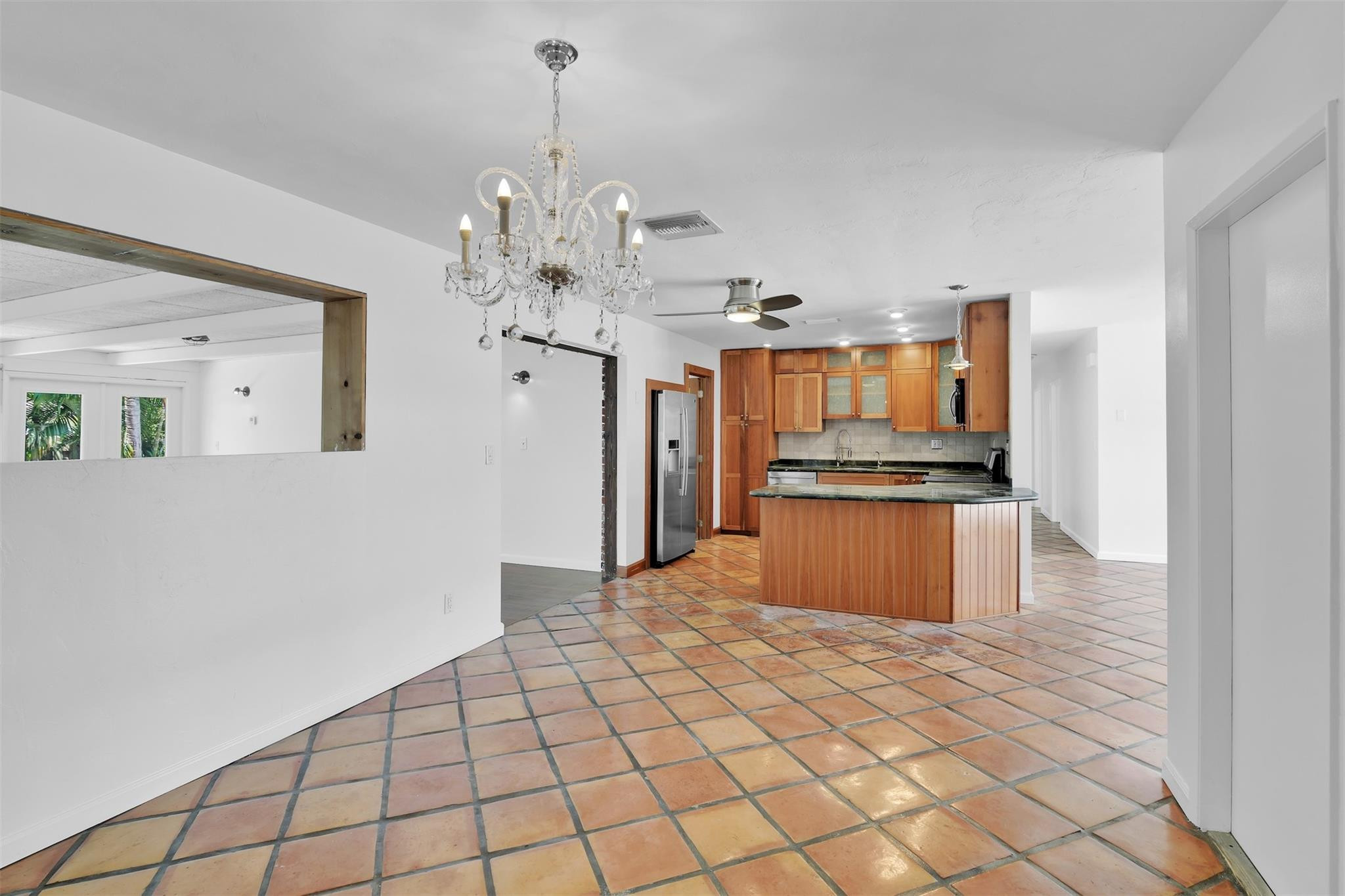341 Southeast 8th Street Pompano Beach, FL 33060 - Photo 11 of 56 a kitchen with stainless steel appliances kitchen island granite countertop a refrigerator and a sink