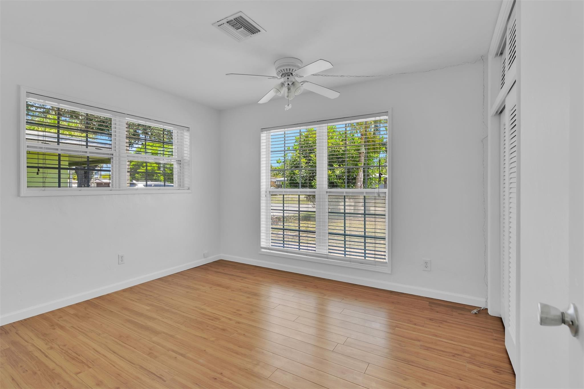 341 Southeast 8th Street Pompano Beach, FL 33060 - Photo 21 of 56 a view of an empty room with wooden floor and a window