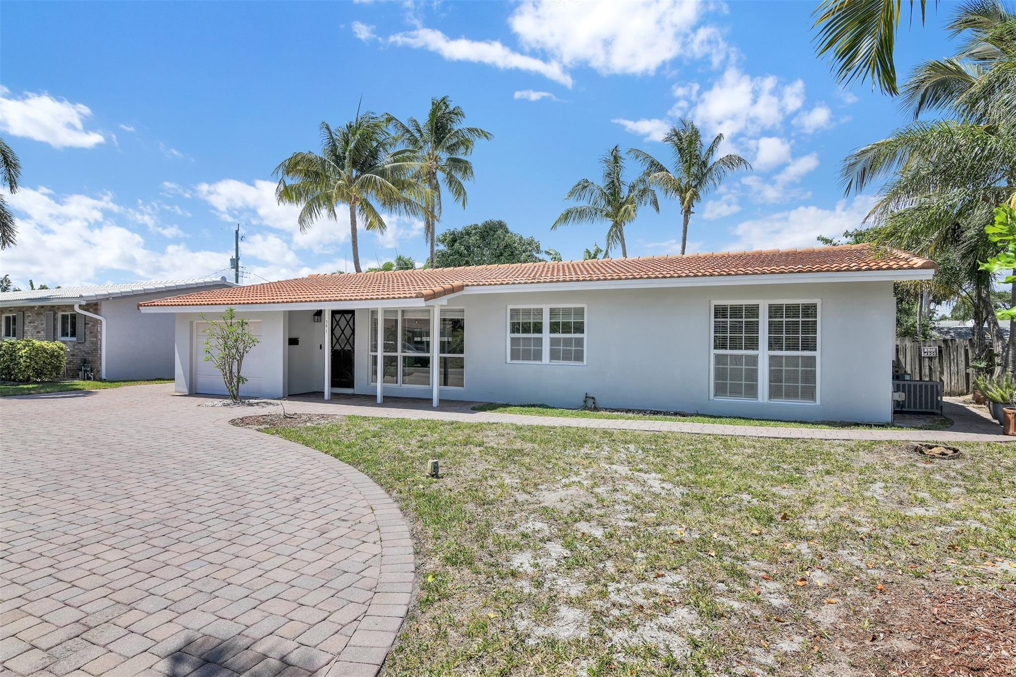 341 Southeast 8th Street Pompano Beach, FL 33060 - Photo 35 of 56 front view of a house with a yard and potted plants