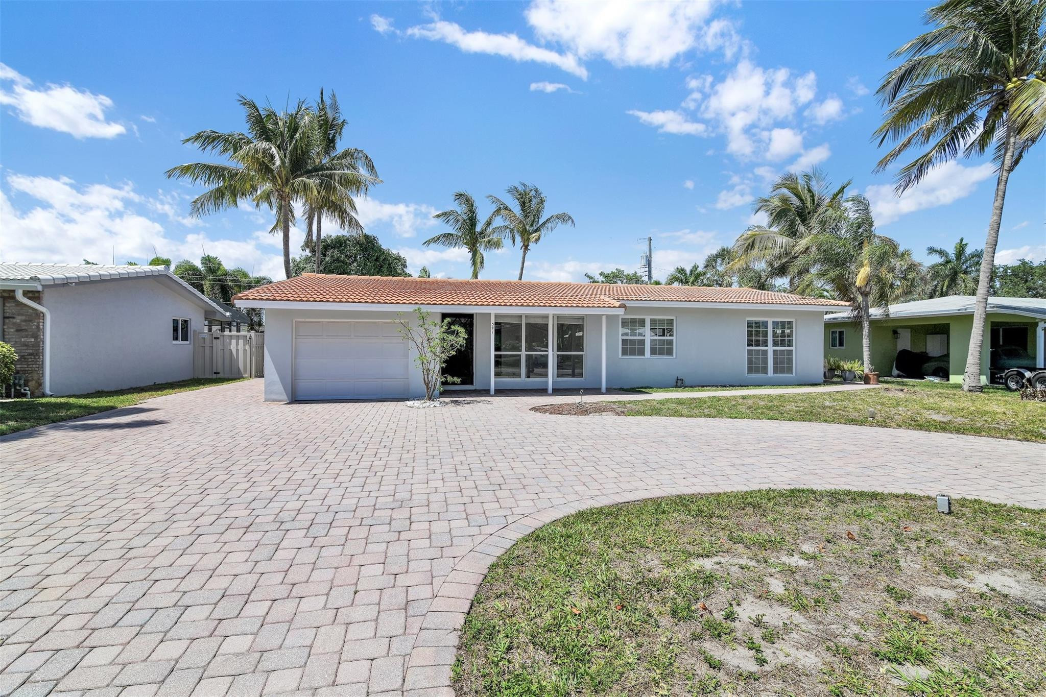 341 Southeast 8th Street Pompano Beach, FL 33060 - Photo 36 of 56 a front view of a house with a garden