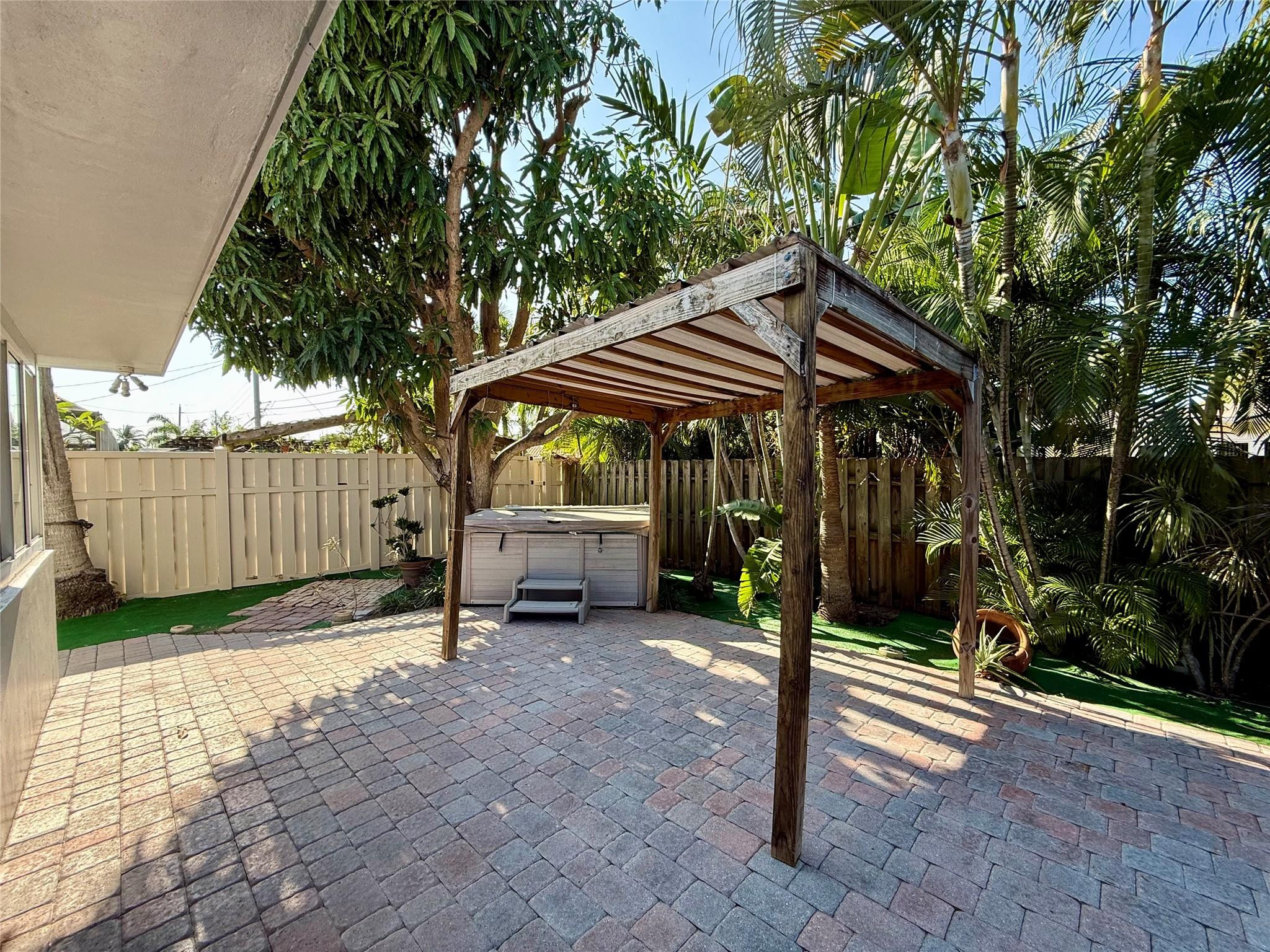 341 Southeast 8th Street Pompano Beach, FL 33060 - Photo 43 of 56 a view of a chair and table in backyard of house