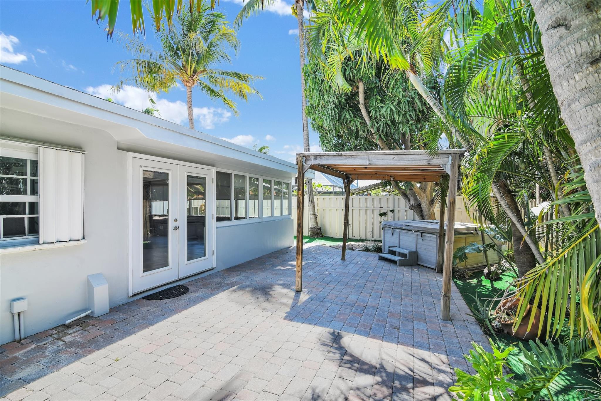 341 Southeast 8th Street Pompano Beach, FL 33060 - Photo 49 of 56 a view of a patio with table and chairs and potted plants