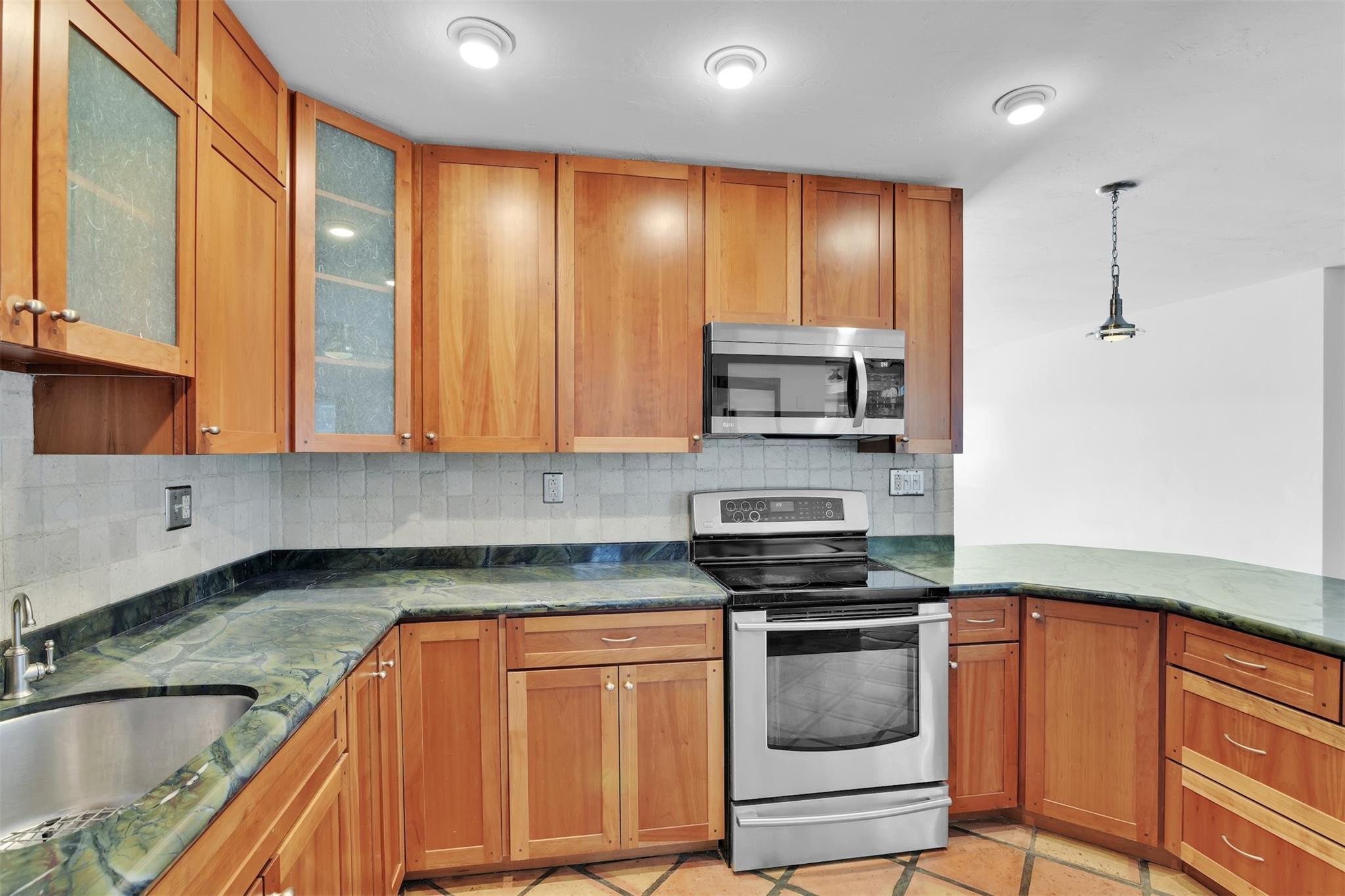 341 Southeast 8th Street Pompano Beach, FL 33060 - Photo 5 of 56 a kitchen with stainless steel appliances granite countertop a stove and a sink