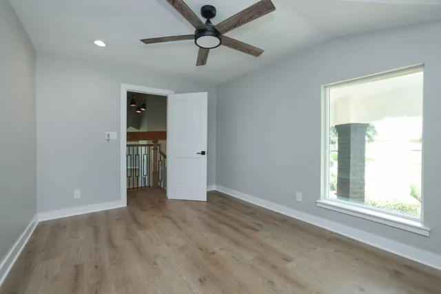 an empty room with closet and a window