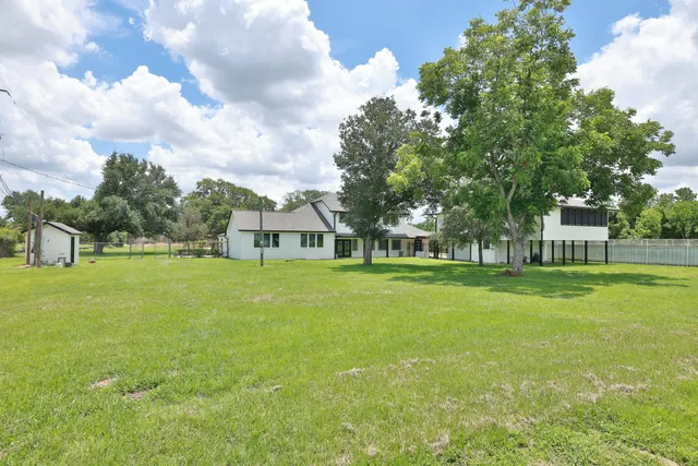 a view of a house with garden and trees