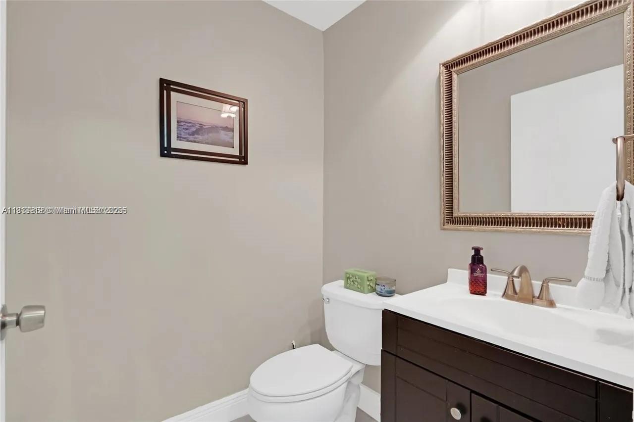 8422 Northwest 140th Terrace, Unit 3608 Miami Lakes, FL 33016 - Photo 11 of 23 a white toilet sitting next to a bathroom sink