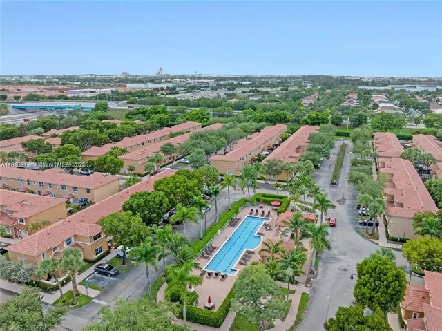 an aerial view of residential houses with outdoor space and street view