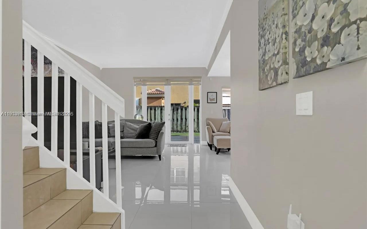 8422 Northwest 140th Terrace, Unit 3608 Miami Lakes, FL 33016 - Photo 2 of 23 a living room with furniture and a couch