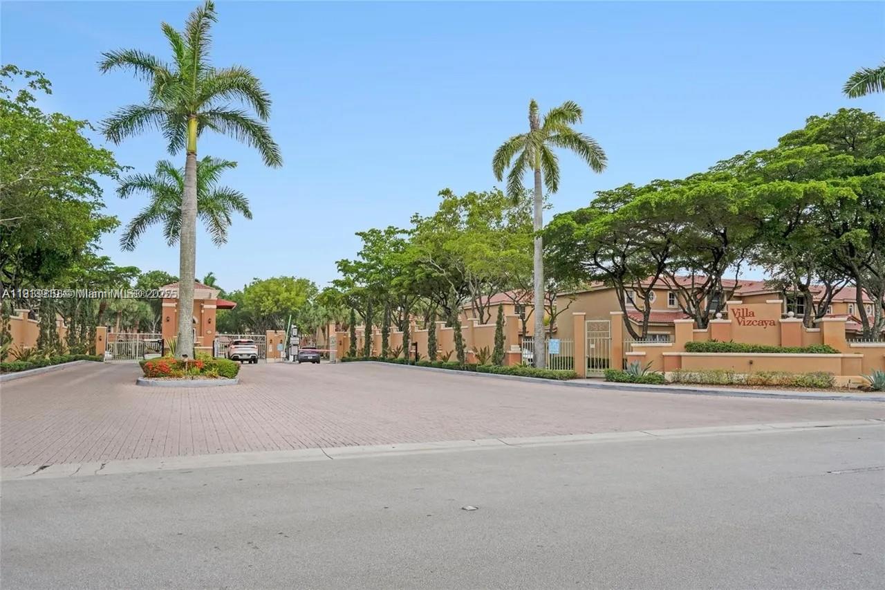 8422 Northwest 140th Terrace, Unit 3608 Miami Lakes, FL 33016 - Photo 21 of 23 a view of a street with palm trees