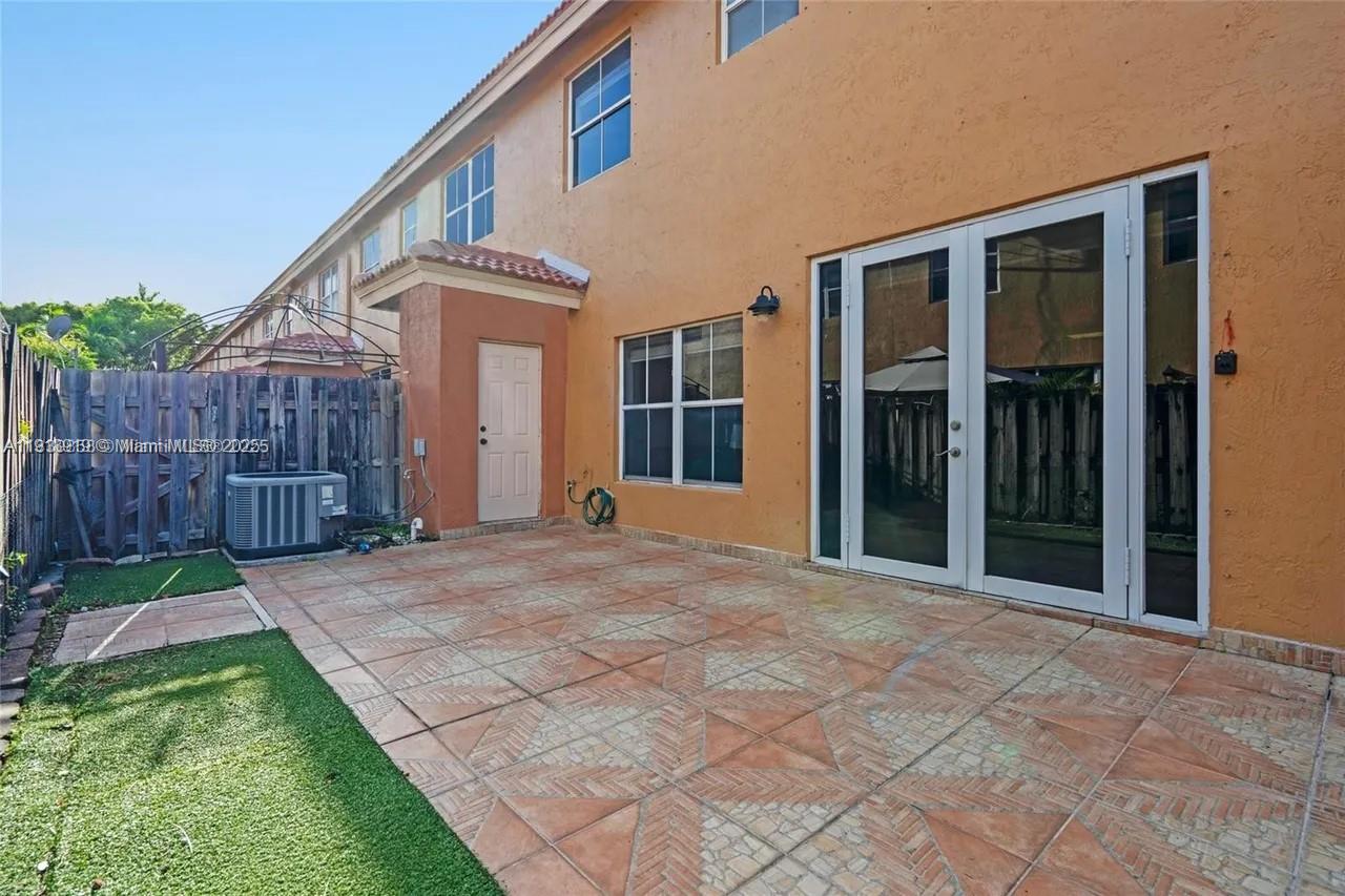 8422 Northwest 140th Terrace, Unit 3608 Miami Lakes, FL 33016 - Photo 4 of 23 a view of a house with backyard and wooden fence