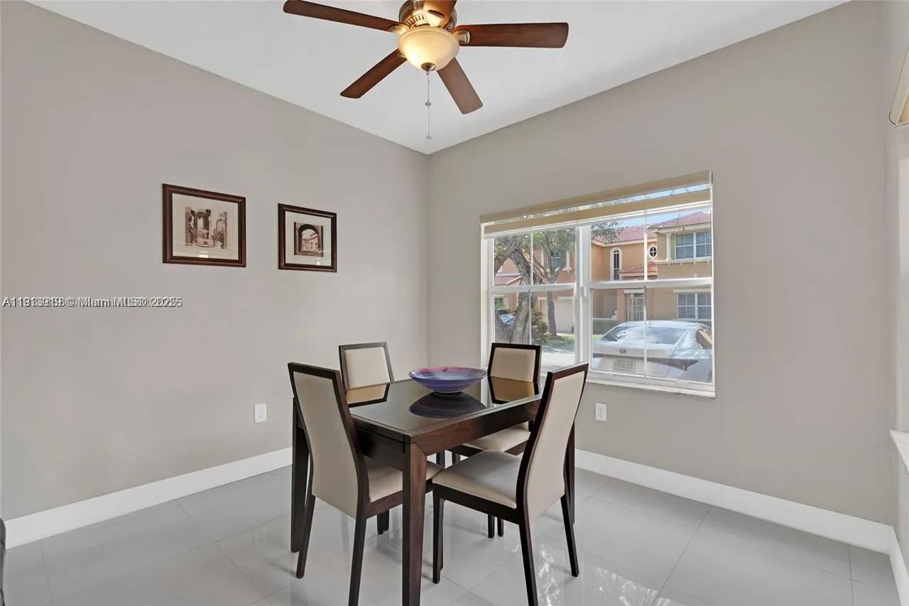 8422 Northwest 140th Terrace, Unit 3608 Miami Lakes, FL 33016 - Photo 6 of 23 a dining room with furniture and window