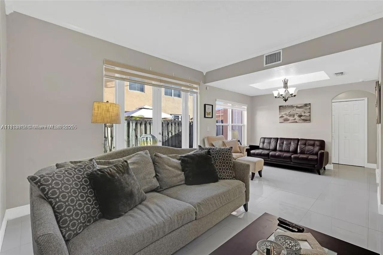 8422 Northwest 140th Terrace, Unit 3608 Miami Lakes, FL 33016 - Photo 10 of 23 a living room with furniture and a large window