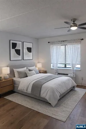 a bedroom with a bed and a large window