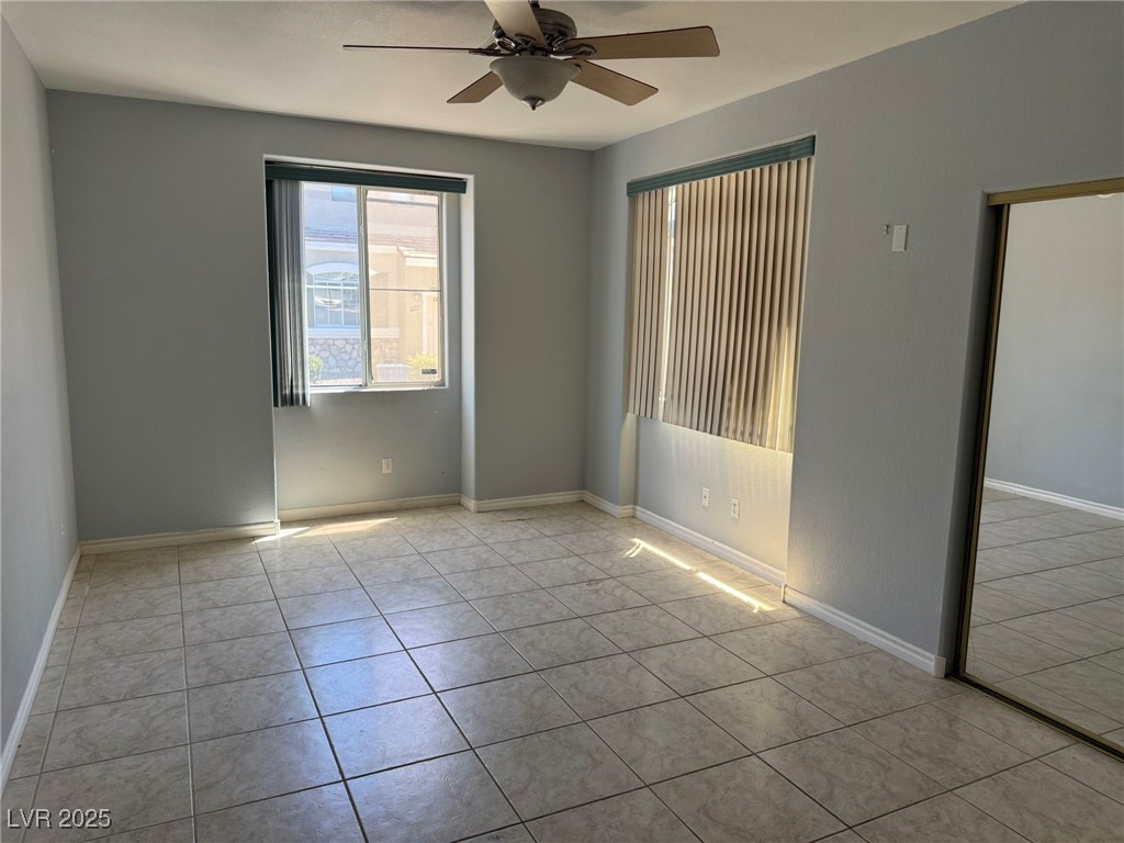985 Prestwick Street Las Vegas, NV 89145 - Photo 14 of 27 Tiled empty room featuring ceiling fan and baseboards