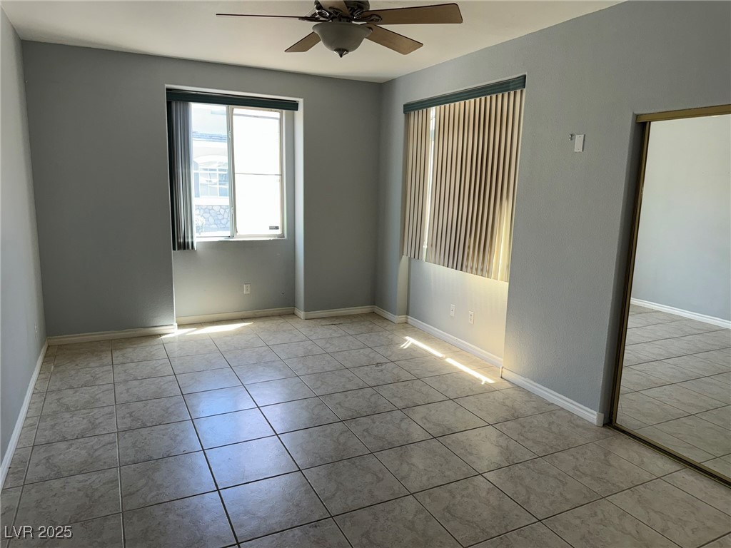 985 Prestwick Street Las Vegas, NV 89145 - Photo 16 of 27 Empty room with ceiling fan and tile patterned flooring