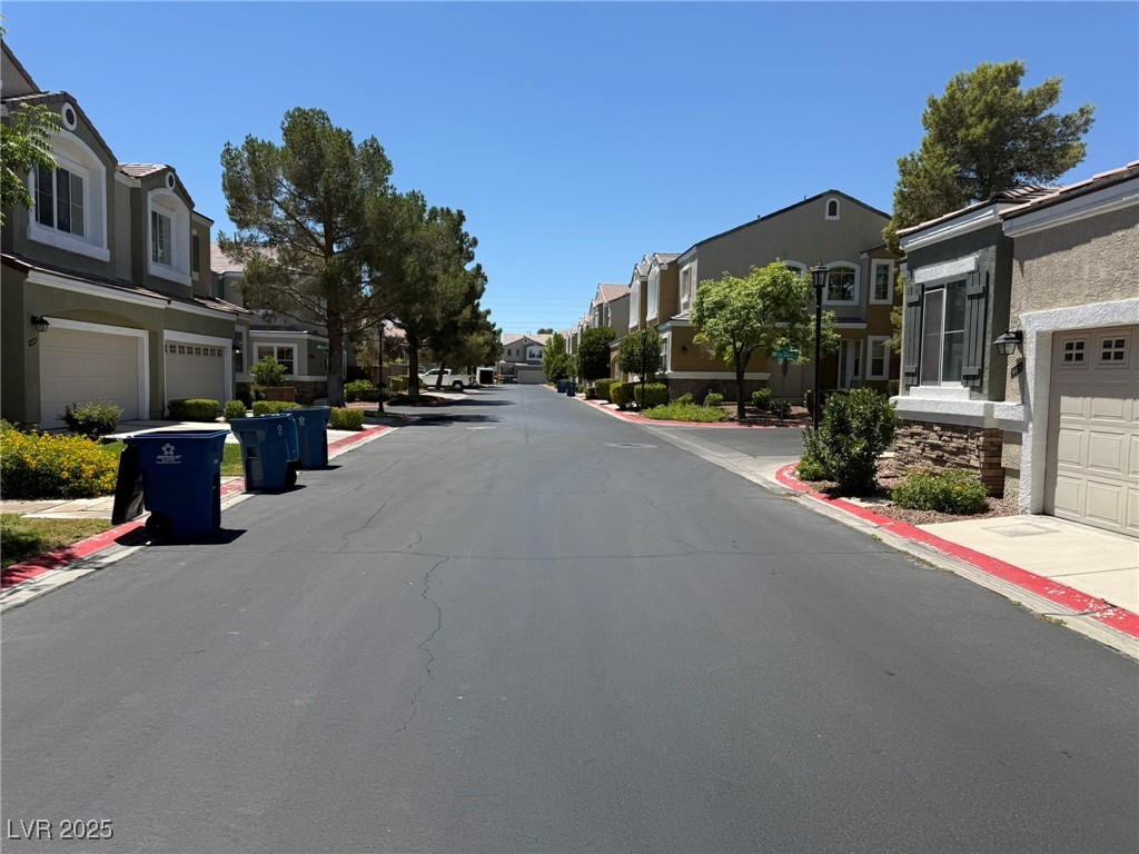 985 Prestwick Street Las Vegas, NV 89145 - Photo 2 of 27 View of asphalt road featuring a residential view, curbs, and sidewalks