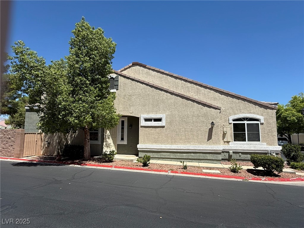 985 Prestwick Street Las Vegas, NV 89145 - Photo 7 of 27 View of front of house featuring stucco siding