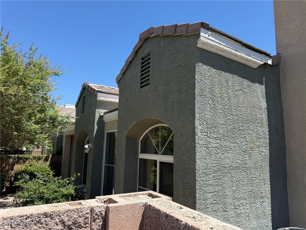 985 Prestwick Street Las Vegas, NV 89145 - Photo 9 of 27 View of property exterior featuring stucco siding