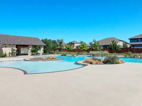 a view of a swimming pool and a yard