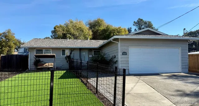 a view of a house with a backyard and a patio