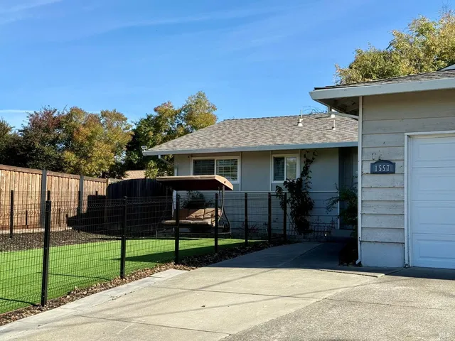 a view of a house with wooden fence